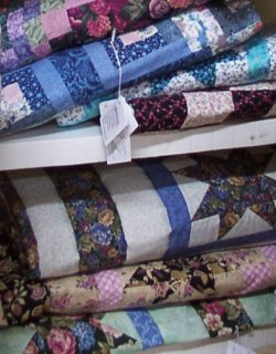 Shelves stacked with Parlor and Lap Quilts at Long Meadow Farms Quilts retail shop